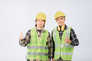 Two young Asian engineers in light green coats and yellow hats are praising your work congratulating on white background.