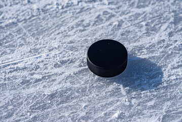 hockey puck lies on the snow close-up