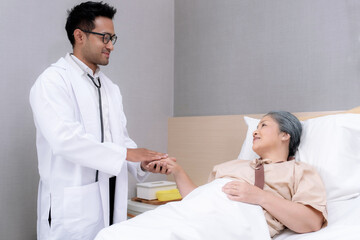 Asian Doctor assisting elderly people at retirement home.