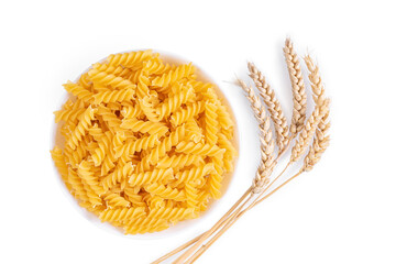 Pasta and wheat spikelets isolated on white background. Raw pasta fusilli, ingredient for cook, traditonal italian cuisine. Flat lay, top view