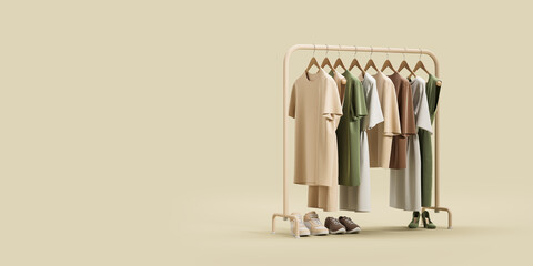 Rack with clothes and shoes over beige background