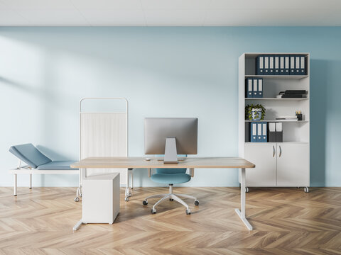 Blue doctor office interior with examination couch and table