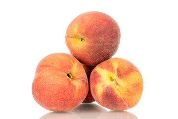 Three ripe organic peaches, macro, isolated on white background.