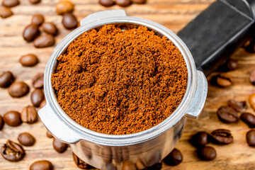 ground coffee beans on a wooden background