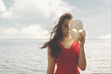woman hiding half face behind a mask, abstract concept