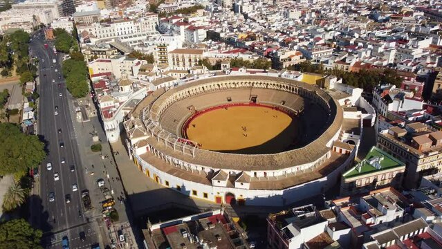 Seville, Spain: Aerial drone footage of the famous Plaza de Toros of the Maestranza, the bull fighting ring, in the heart of Seville historic city center in Andalusia. 