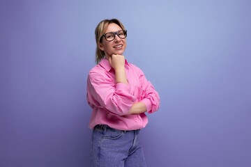 Fototapeta premium smart young blond businesswoman in a pink shirt and jeans is confident in her business on a studio background with copy space