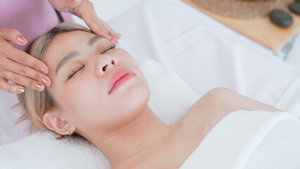 Obraz na płótnie Canvas Woman having facial massage by masseuse.
