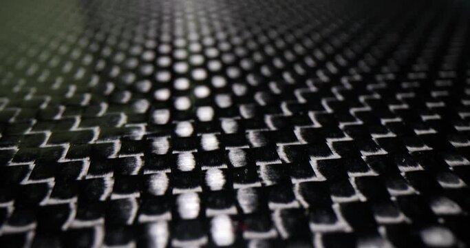 Black and white patterned carbon plate background closeup. Dark polyester fiber material and mesh black texture
