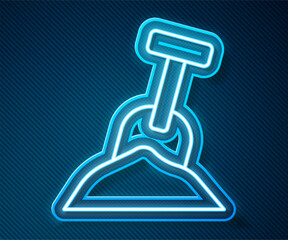 Glowing neon line Sandbox with sand and shovel icon isolated on blue background. Vector