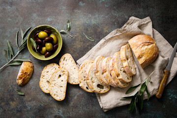 Ciabatta bread sliced on a board, top view - 621223358
