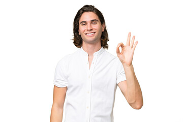 Young caucasian man isolated on green chroma background showing ok sign with fingers