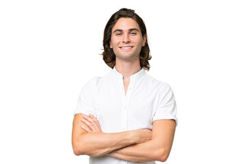 Young caucasian man isolated on green chroma background keeping the arms crossed in frontal position