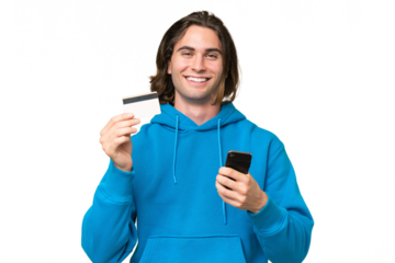 Young handsome man isolated on green chroma background buying with the mobile with a credit card