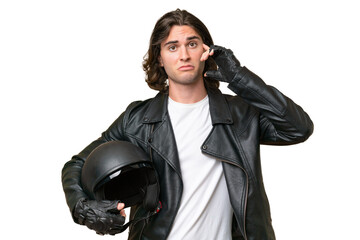 Fototapeta premium Young handsome man with a motorcycle helmet isolated on green chroma background thinking an idea