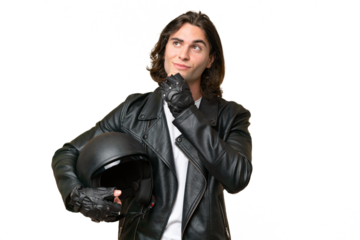 Young handsome man with a motorcycle helmet isolated on green chroma background and looking up