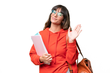 Young student caucasian woman over isolated background saluting with hand with happy expression