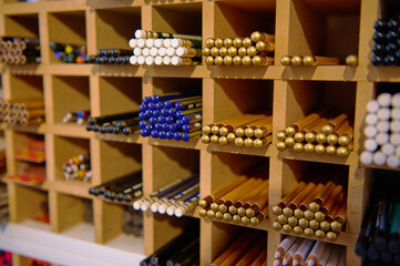 Close-up shot. A large assortment of various graphite pencils in different softness for sale in school stationery store