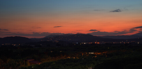 Lights of the Costa Brava, Blanes, Spain. Landscape of mountains against the sunset sky