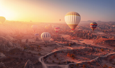 Beautiful romantic sunrise landscape in Cappadocia with colorful hot air balloon deep canyons, valleys from aerial view. Concept banner travel Turkey