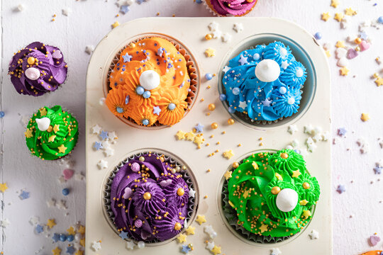 Cute and sweet multicolored cupcakes with flower shaped cream.