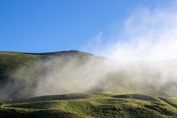Fototapeta premium Fog and sunny mountains. Beautiful green mountains, nature.