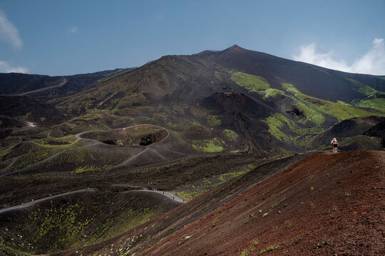 The otherwordly landscape of the Etna volcano with some smaller craters.