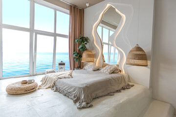 the interior of the bedroom in Balinese style by a large window with an awesome view of the sea....