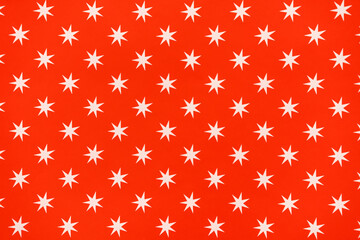 white stars on red paper background holiday pattern