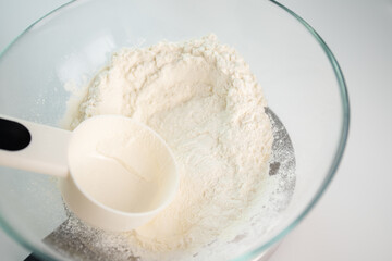 dough and pastry preparation, flour in a bowl on an electronic kitchen scales,