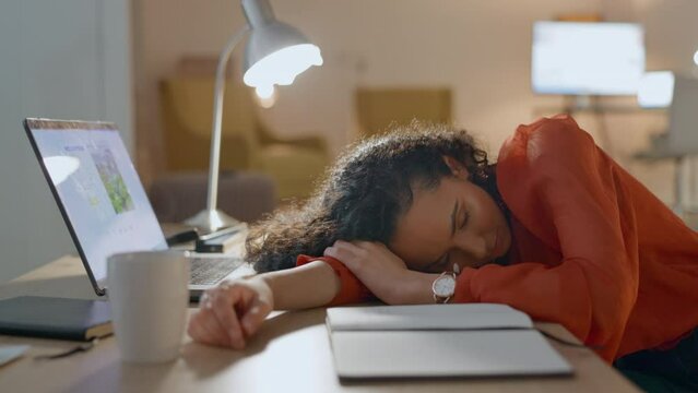 Tired, sleeping and woman, computer and night for fatigue, time management and and mental health risk. Business person or employee with career dream or depression on laptop, notebook and job deadline