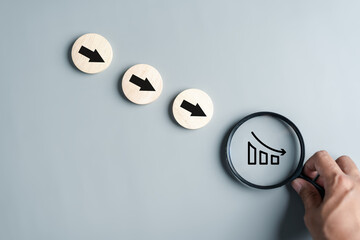 Magnifier focus to chart money loss decreasing arrows down concept. Financial interest rates...