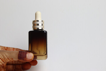 Blank Serum bottle in hand with isolated background 