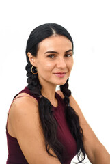 Portrait of ukrainian woman with braids looking at camera against white background