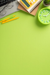 Immerse yourself in the world of online education with this captivating vertical top-view image showcasing laptop, notepads and office supplies on light green backdrop. Perfect for text or advertising