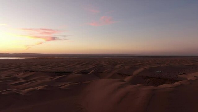 aerial view traveling in and at sunset over the Shahara desert
