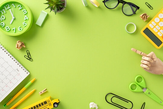 Explore the educational journey through this captivating top-down image featuring a messy child's workspace on an isolated light green background, offering ample copy-space for text or advertising