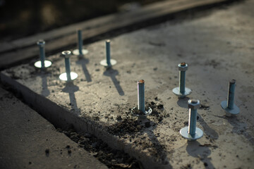 Construction of foundation. Steel bolt in concrete. Fasteners for frame.