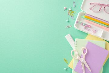 Dive into the educational process with this top-view shot displaying glasses and collection of school supplies on isolated pastel blue backdrop, copy-space allows for personalized text or promotions