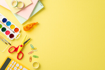 Embark on a successful educational journey with this top-down photograph of meticulously arranged school items on yellow background. Use the empty space to include text or advertisements.