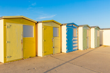 Fototapeta na wymiar Colourful beach huts in a row. Seaford, East Sussex