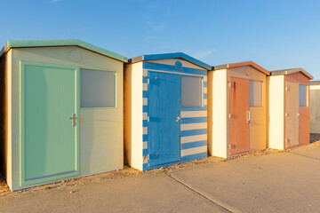 Colourful beach huts in a row. Seaford, East Sussex