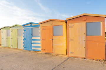 Obraz na płótnie Canvas Colourful beach huts in a row. Seaford, East Sussex