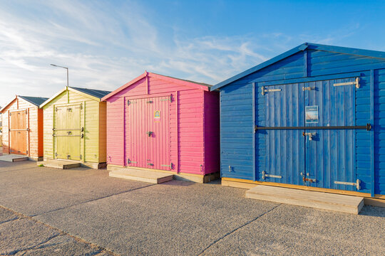 Colourful beach huts in a row. Seaford, East Sussex
