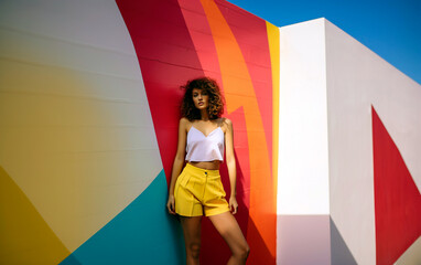 Fashion portrait of young stylish trendy look woman model over colorful wall. Street style natural light photo. Generative AI.