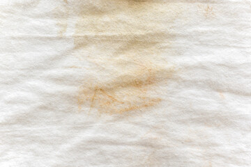 Dirty white cotton fabric.  Stains on shirt.  Dirty clothes texture background. 