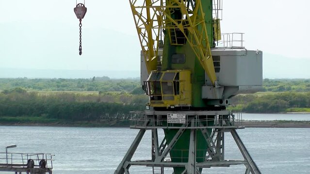 A large port crane stands motionless