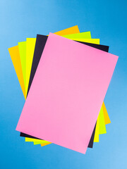 Colorful paper sheet background  isolated on blue, close up