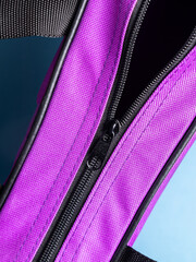 close up of the zipper on purple  bag background