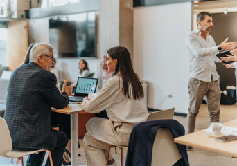 People involved at the work while drinking coffee and communicating in the office